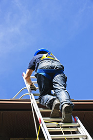 Mann steigt über eine Leiter auf eine hochgelegene Arbeitsfläche