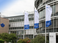 Das Verwaltungsgebäude in Heidelberg mit drei Fahnen und BG RCI-Logo